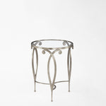 Round side table with silver leaf and glass top.