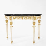Ornate white and gold console table with black marble top.