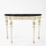 Ornate white and silver console table with black marble top.